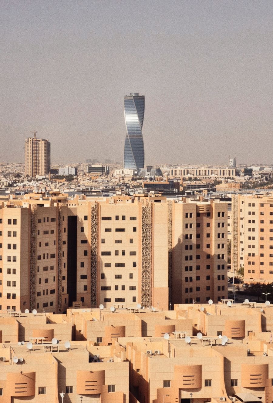 Aerial view of the Riyadh skyline with a distinctive twisting tower