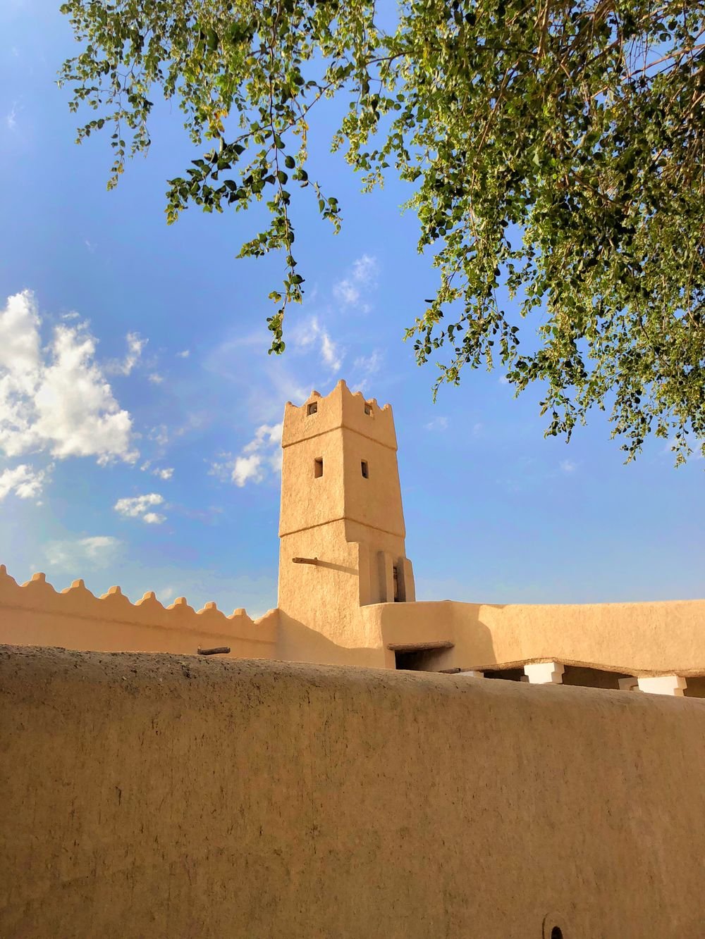 Historic mud-brick tower of Masmak Fort in Riyadh under a blue sky