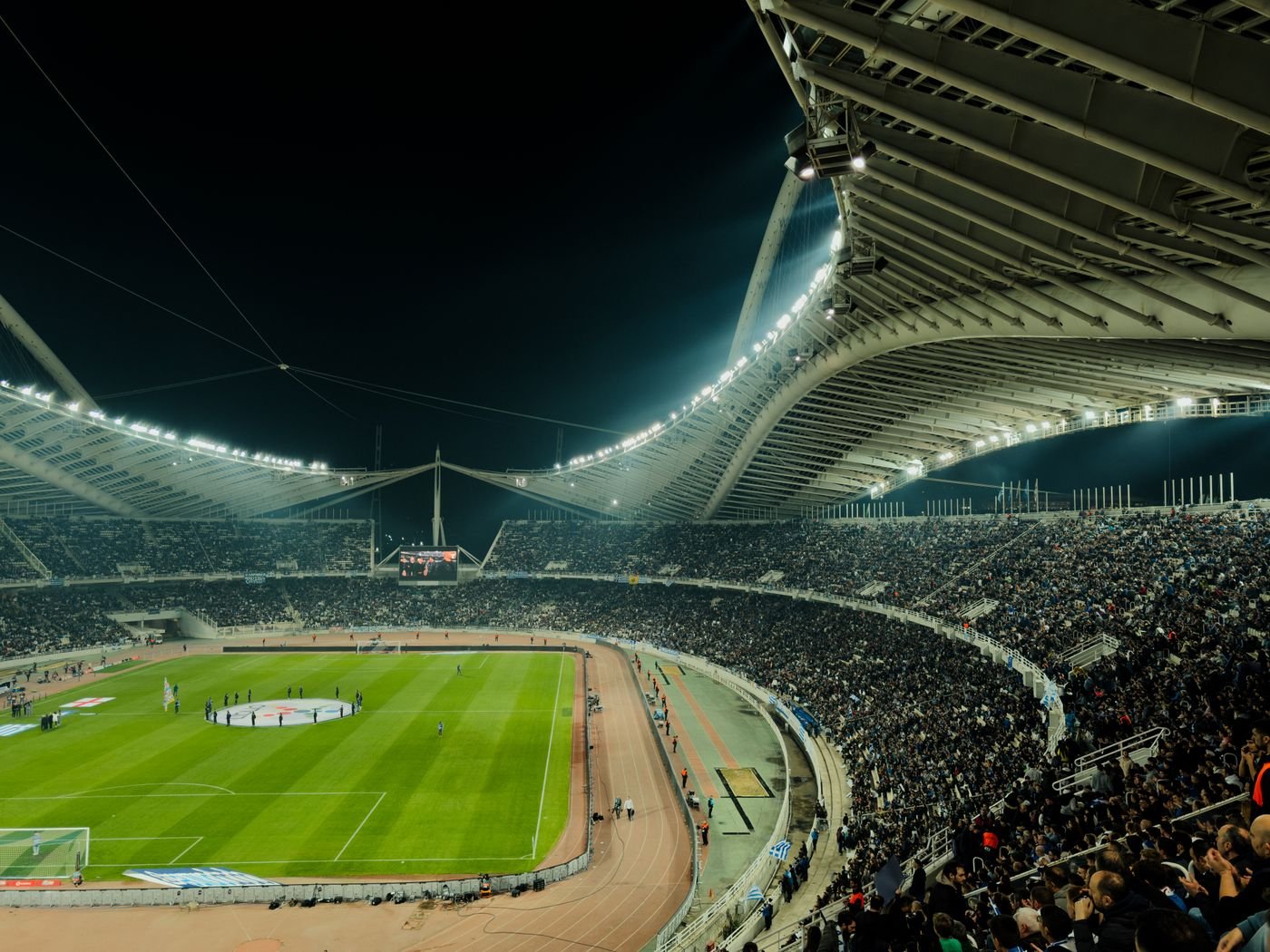 Football stadium under bright lights at night